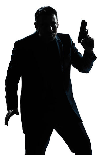 istock silhouette man portrait with gun 136801031