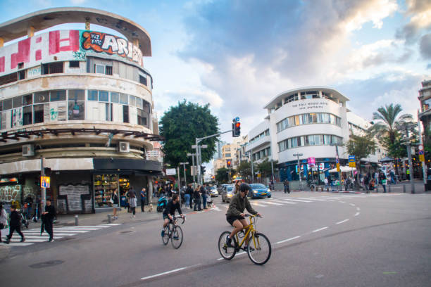 Tel Aviv, Israel - December 24, 2021: Cyclist, traffic and buildings on King George, Allenby streets.