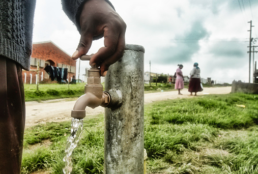 Water running out of a faucet in a rural area in Africa