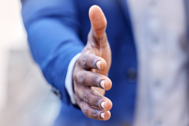 istock Shot of an unrecognizable businessman extending his hand for a handshake at work 1368013267