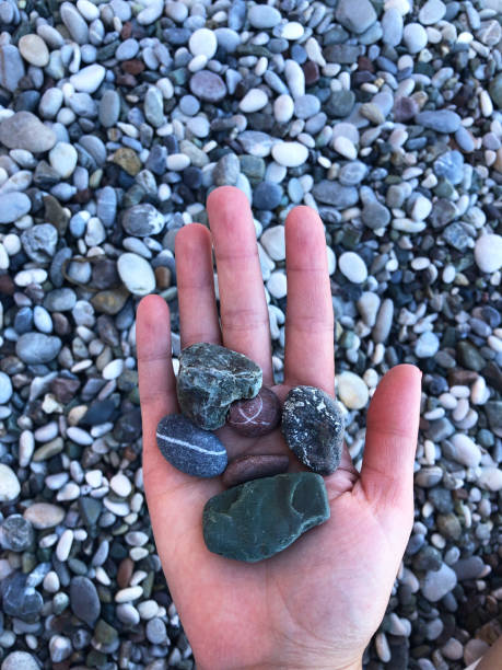 istock Kemer Beach Hand with Stones 1368014396