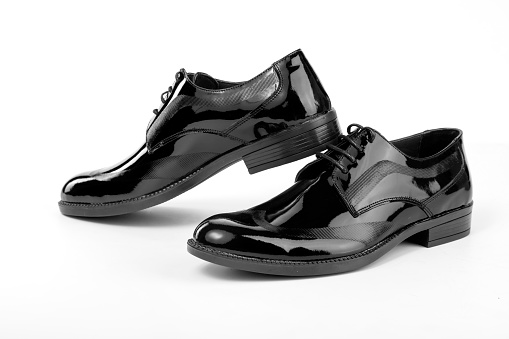A pair of classic black men's shoes on a white background