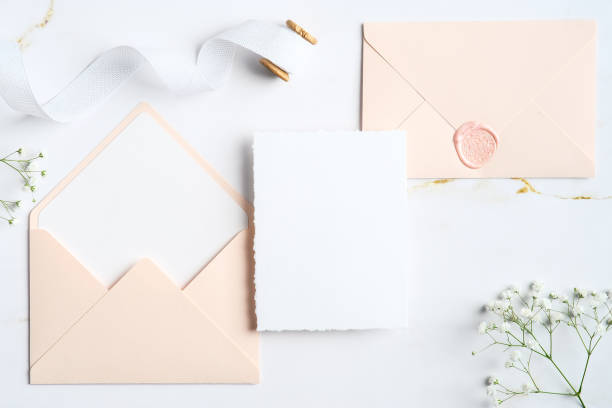 istock Elegant wedding invitation card template and envelopes on marble stone. Wedding stationery set. Flat lay, top view, copy space. 1368015886