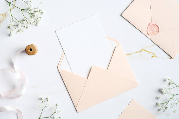 istock Envelope with wedding invitation card inside on marble table. Wedding stationery set. Flat lay, top view, copy space. 1368015887