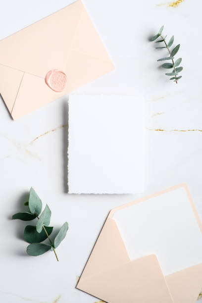istock Flat lay wedding invitation card mockup with eucalyptus branches and envelopes on marble table. Top view with copy space. Elegant wedding stationery set. 1368015897