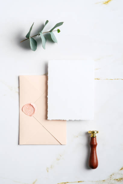 istock Wedding invitation card mockup, envelope, wax seal stamp, eucalyptus branch on marble table. Wedding stationery set. Flat lay, top view. 1368015905