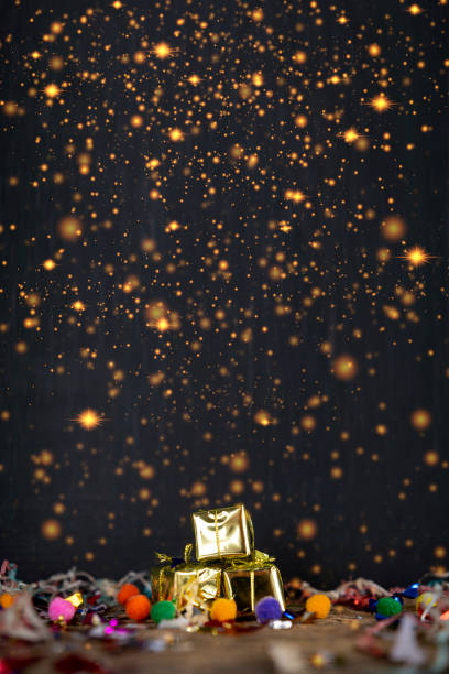 christmas gift in golden paper isolated on black background