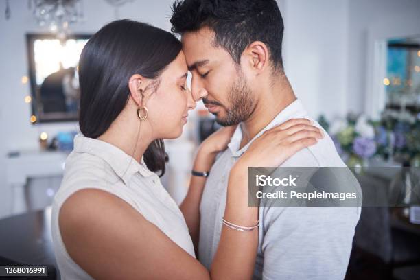 Shot Of A Young Couple Making Up After An Argument At Home Stock Photo - Download Image Now