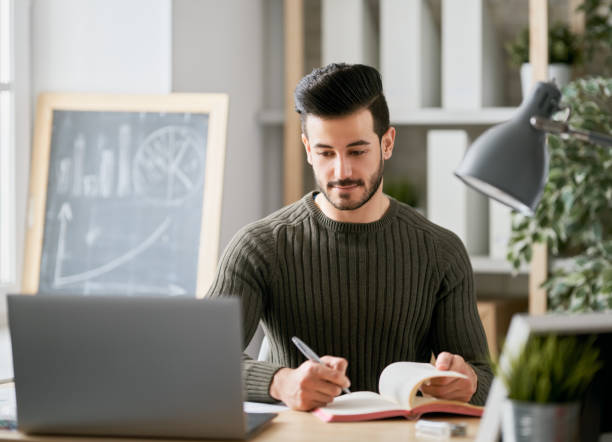 istock man working on a laptop at home. 1368017486