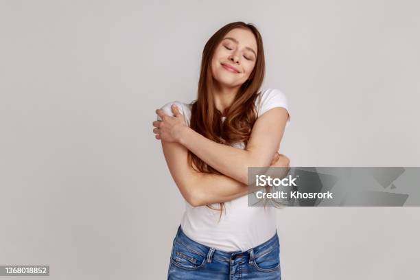 Narcissistic Woman Embracing Herself Feeling Safe And Comfortable Satisfied With Appearance Stock Photo - Download Image Now