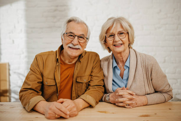 istock Senior couple at home smiling at camera 1368018885