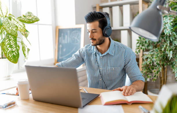 istock man working on a laptop at home 1368019045