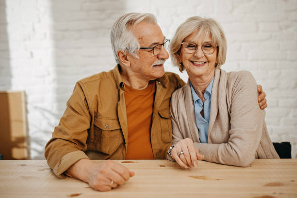 istock Senior couple at home smiling at camera 1368019053