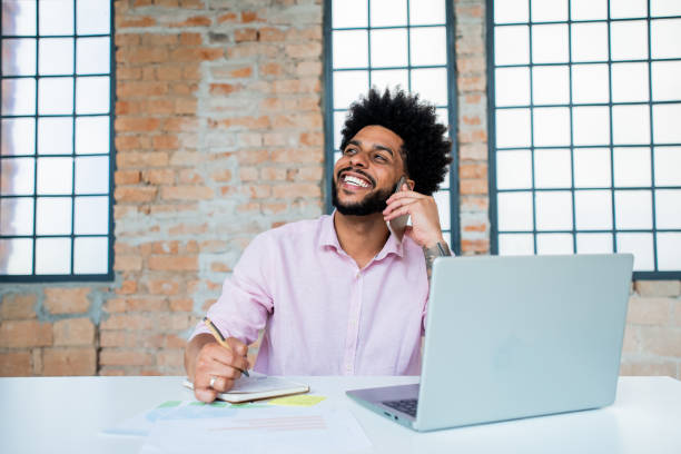 istock Portrait of a young man working on laptop 1368019289