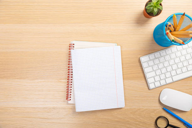 istock office stuff with pen and notepad keyboard on light wooden table top view. work at home 1368020063