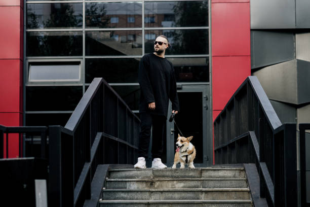 istock man in stylish clothes and a small dog. 1368020391