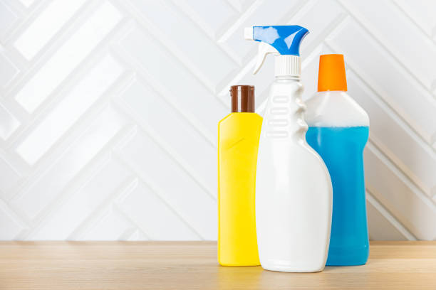 istock Cleaning bottles for different surfaces in kitchen, bathroom and other rooms. close up. top view. wide banner. Empty place for text or logo. 1368020467