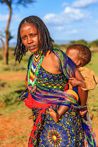Woman from Borana tribe carrying her baby. The Borana Oromo are a pastoralist tribe living in southern Ethiopia and northern Kenya