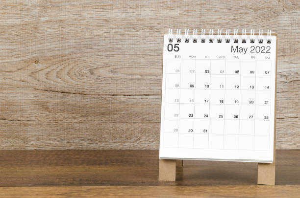 istock May 2022 desk calendar on wooden background. 1368022876