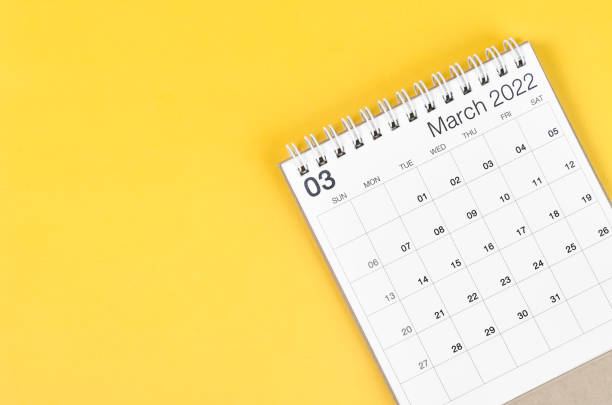 istock March 2022 desk calendar on yellow background with empty space. 1368022879