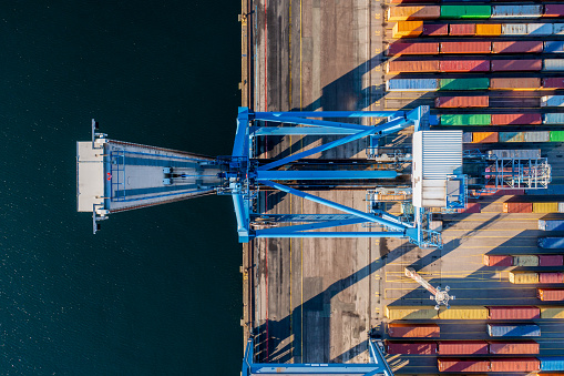 Aerial top down drone view of crane at a container terminal