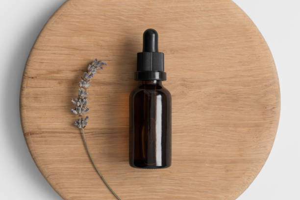 istock Dropper bottle mockup with lavender on the wooden background. 1368024868
