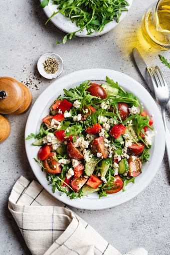 istock Healthy vegetarian salad with tomatoes, arugula and goats feta cheese 1368025592
