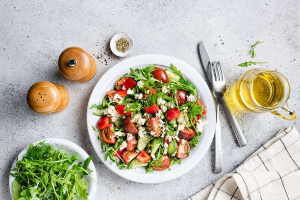 istock Healthy vegetable salad with arugula, tomatoes and goats cheese 1368025593