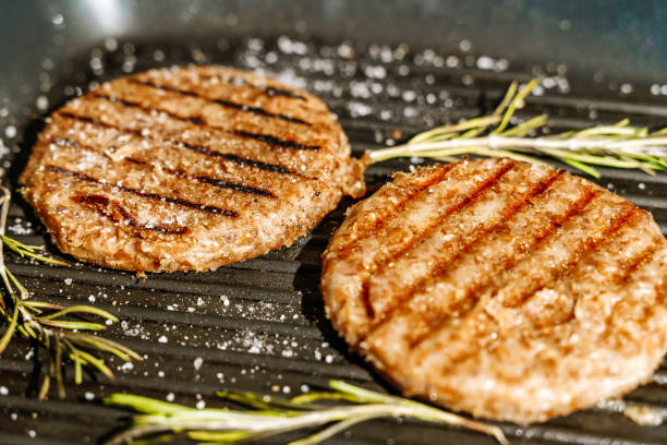 la chuleta vegetariana se asa a la parrilla para la hamburguesa vegetariana. productos vegetarianos del concepto de carne a base de plantas, más allá del fondo de la cocina - hamburguesa vegetariana fotografías e imágenes de stock