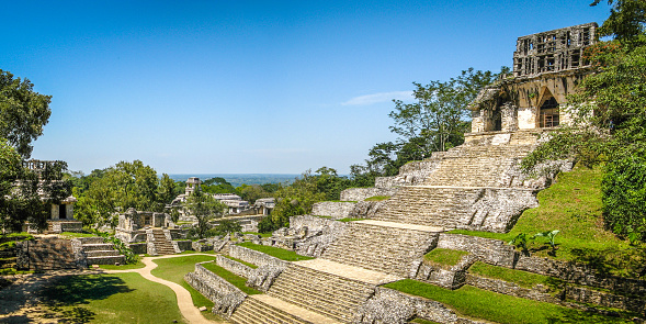 The Temple of the Cross pyramid, in the foreground, is one of the biggest known structures of the ancient Maya City of Palenque, located in Mexico's southern state of Chiapas. After its abandonment, it was slowly absorbed into the jungle, before being rediscovered hundreds of years later.\nDespite extensive excavations in the past decades, archeologist estimate that less than 10% of the site has been explored so far, and that over a thousand buildings are still buried.