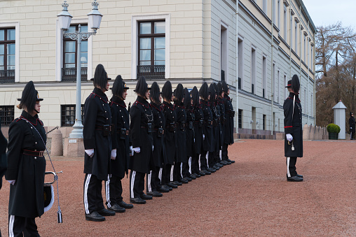 Copenhagen, Denmark - 04/28/2019: Infantry soldiers of the Royal Life Guards of Denmark (Den Kongelige Livgarde) awaiting the change of guards at historic castle Amalienborg.