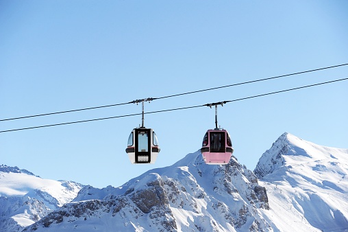 Vintage ski gondolas over the snowy mountains