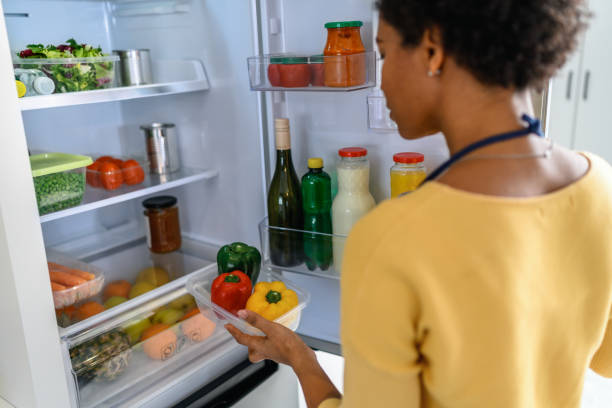 Woman looking at food in refrigerator