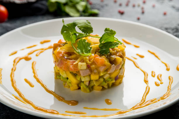istock salmon Tartar on a plate on dark stone table 1368038066