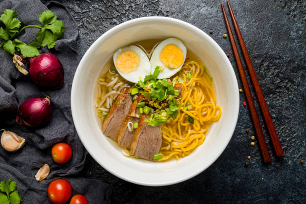 istock Ramen soup with pork on white bowl on dark stone table top view 1368038314