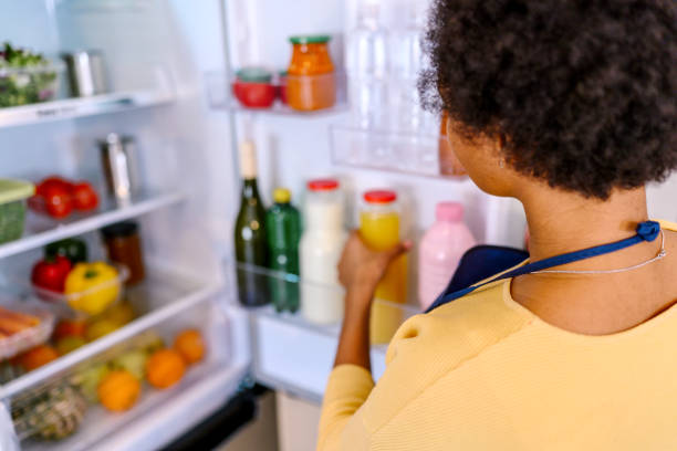 istock Woman looking at food in refrigerator 1368038476