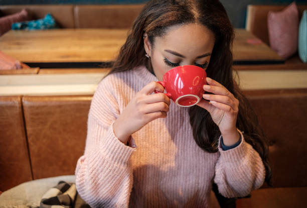 istock Young black woman is having coffee indoors. 1368038500