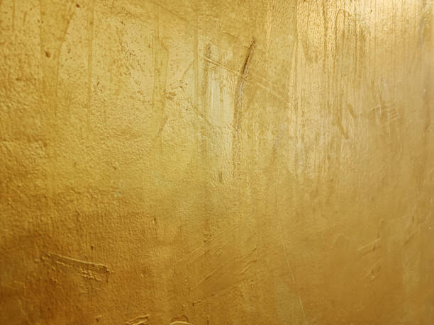 istock old grunge gold wall texture background with blank space for design (focus at center of image). gold or foil cement wall texture background. metallic wall. 1368039210