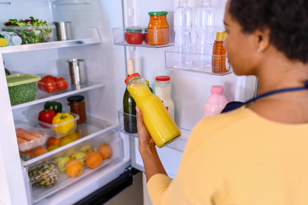 istock Woman looking at food in refrigerator 1368039399