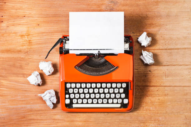 istock An orange vintage typewriter on a wooden table 1368039482