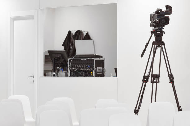 istock TV control room with video camera. Conference hall. Live show 1368039830