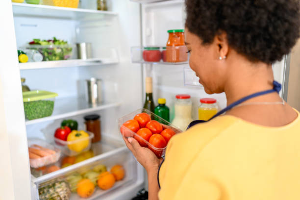 istock Woman looking at food in refrigerator 1368040150