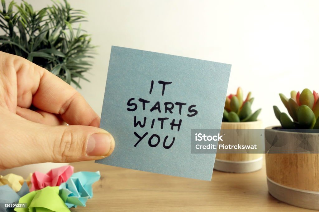 Words it starts with you handwritten on sticky note. Business planning concept Words it starts with you handwritten on sticky note. Business planning, self improvement and change management concept Motivation Stock Photo