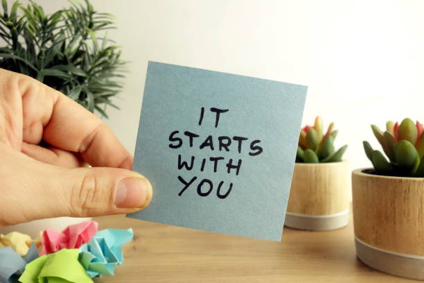 words it starts with you handwritten on sticky note. business planning concept - motivação imagens e fotografias de stock