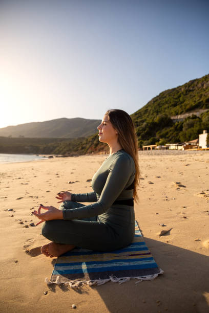 istock Woman enjoying the sun at the beach 1368044013