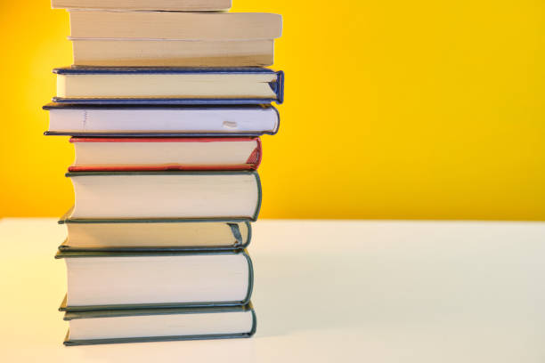 istock Collection of Book stack in the library room on yellow background 1368044150