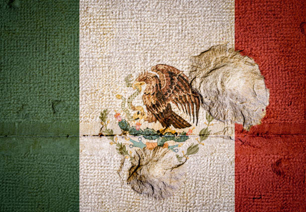 Stone wall with the flag of Mexico and Bullet holes stock photo