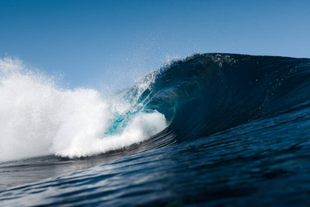istock Blue wave splashing on a beach in summer 1368048852
