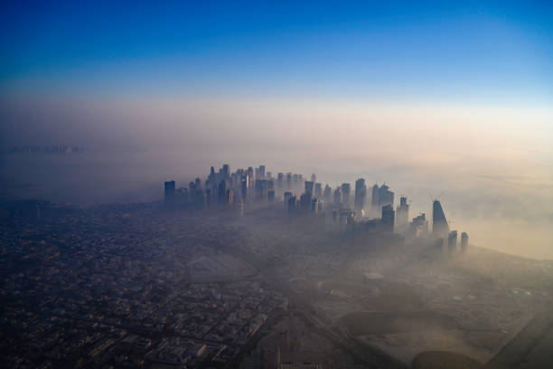 Doha skyline at sunrise with morning fog in Doha, Doha, Qatar