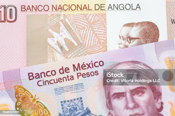 A Pink Plastic Fifty Peso Bank Note From Mexico Paired With A Colorful Ten Kwanza Bank Note From Angola Stock Photo - Download Image Now